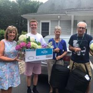 Home delivered meals staff and volunteers with meals and hydrangeas