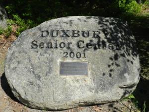 A Huge Rock with the Words Duxbury Senior Center 2001 on it