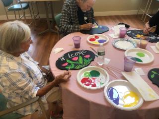 photo of painting a welcome sign
